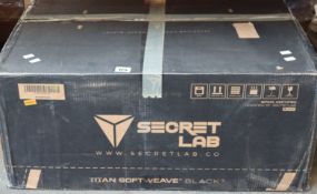 A boxed Secret Lab Omega Softweave Black 3 Gaming Chair.