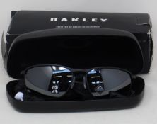 A pair of as new Oakley Conductor 8 sunglasses.