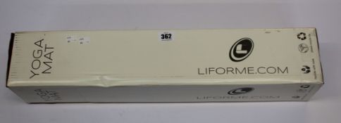 A boxed as new Liforme yoga mat in green and a pre-owned Liforme yoga mat in white magic.