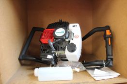 A petrol earth auger/fence post earth borer engine.