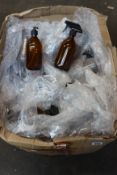 A quantity of Nomara Organics amber glass soap dispenser bottles and amber glass spray bottles.