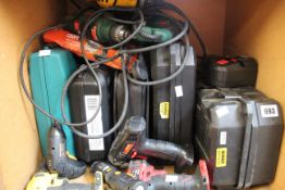 A shelf containing assorted tools including drills and electric screwdrivers.