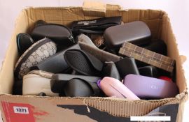 A box of branded sunglasses and a box of wallets/purses.