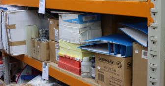 A shelf containing stationery and related items.