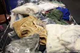 A quantity of assorted as new clothing and related items.