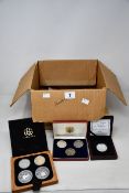 A box of coin collections to include many silver proof coins, plus old silver coins, uncirculated