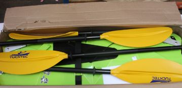 A boxed Tucktec Hardshell Folding Kayak in green.