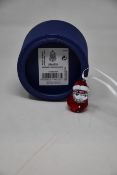 Three boxed as new Swarovski rocking Santa ornaments.
