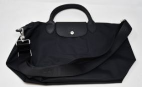 An as new Longchamp bag in black.