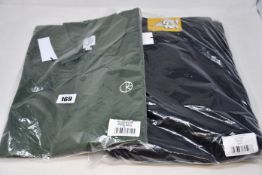An as new Polar pique shirt in hunter green (XL) and a pair of Polar '93 cords (W34/L32).