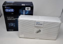 A boxed Oral B Smart Series black 6500 electric toothbrush (Unsealed) and an as new Phillips Zoom