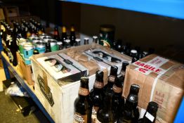 A shelf containing beers/ciders/IPA to include Peaky Blinder, Mud City Stout, Henry Westons, Karmi