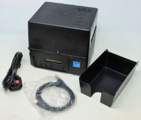 A pre-owned TLS Boca Systems Lemur Thermal Ticket/Label Printer (Untested, sold as seen).