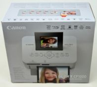 A boxed Canon SELPHY CP1000 Colour Portable Photo Printer in White (Box opened).