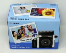 A boxed as new Fujifilm Instax Wide 300 Instant Camera (Box opened).