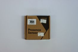 A boxed a new Loxone air presence sensor in White.