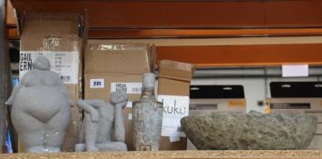 Four items of decorative homeware: Two Abigail Ahern stone sculptures, a large stone pestle and