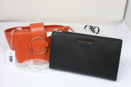 An as new Michael Kors Women's Jet Set Travel crossbody clutch together with a Charles & Keith bag.
