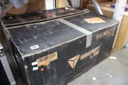 A boxed SecretLab Omega Stealth gaming chair.