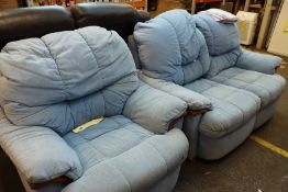 A blue two seater sofa together with an arm chair.