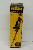 A boxed DeWalt DCM563P1 18v hedge trimmer.