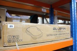 A boxed Bluefin Fitness Ultra Slim vibration plate.