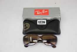 A pair of as new Ray Ban sunglasses.
