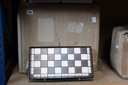 Twelve boxed as new wooden chess sets.