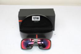 A pair of as new Prada sunglasses.