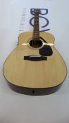 A boxed Yamaha F310 Acoustic guitar in natural finish.
