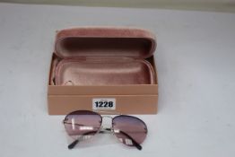 A pair of lady's boxed Miu Miu sunglasses (0MU 54US 1BC157 59).