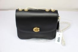 An as new Coach Madison shoulder bag in black.