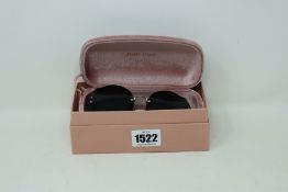 A pair of lady's boxed as new Miu Miu sunglasses (06SS 1AB1A1 63).