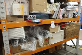 Two shelves of household items to include wallpaper, a desktop lamp and other related items.