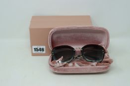 A pair of boxed as new MIU MIU MU02TS sunglasses.