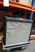 A pre-owned Fender Hot Rod DeVille guitar amp in a wheeled case.