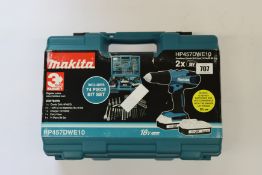 An as new Makita cordless combi drill and 74 piece bit set (HP457DWE10).