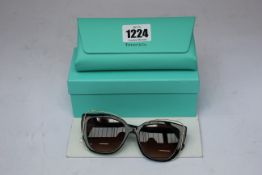 A pair of boxed as new Tiffany & C0 TF4148 black & gold 80013B 54mm sunglasses.