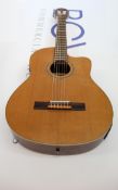 A pre-owned Ortega RCE131SN Electro nylon string guitar.