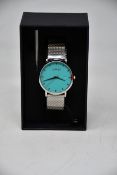 A ladies boxed as new Coluri Watch in turquoise with a spare strap.