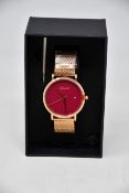 A ladies boxed as new Coluri Watch in red with a spare strap.