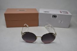 A pair of boxed as new MIU MIU MU52TS - VW7146 sunglasses.