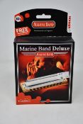 Six boxed as new Hohner Marine Band Deluxe harmonicas (One in Ab, two in A and three in G).