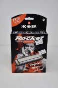 Nine boxed as new Hohner Rocket progressive harmonicas (Five in A, Two in D, One in Eb and one in
