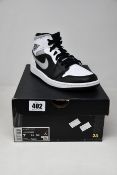 A pair of boxed as new Nike Jordan 1 Mid White Shadow Sneakers (UK 6).