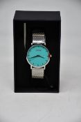 A ladies boxed as new Coluri Watch in turquoise with a spare strap.