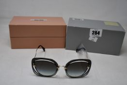 A pair of boxed as new MIU MIU SMU545162 sunglasses.