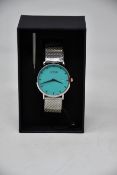 A ladies boxed as new Coluri Watch in turquoise with a spare strap.