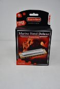 Six boxed as new Hohner Marine Band Deluxe harmonicas (Three in Ab, two in A and one in G).