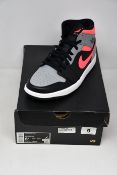 A pair of as new Nike Air Jordan 1 Mid (UK 7.5).